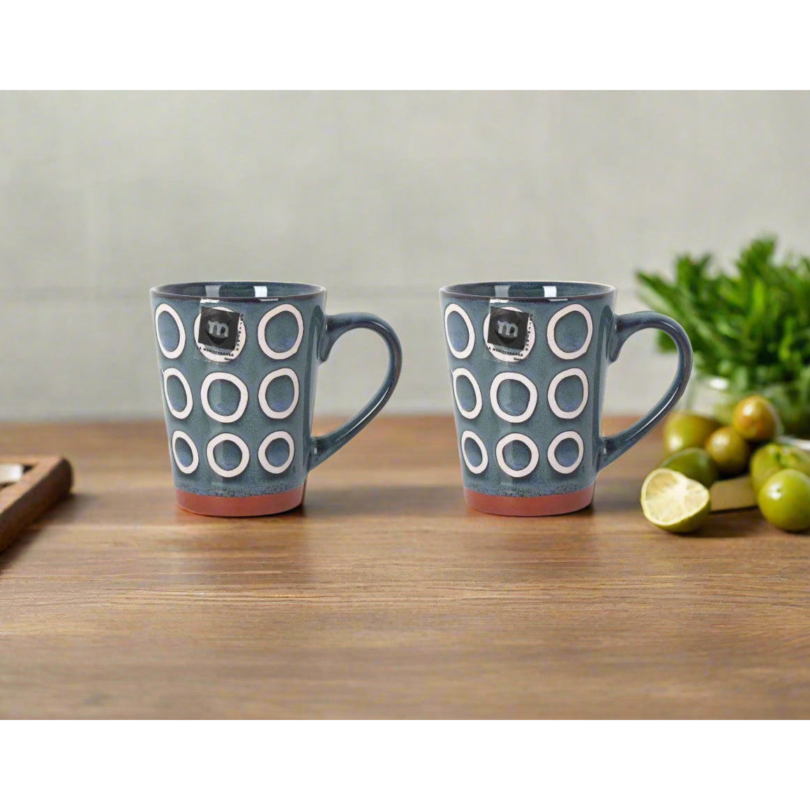 Dark teal Almudena Blue Coffee Mug with white circle patterns and reddish-brown base