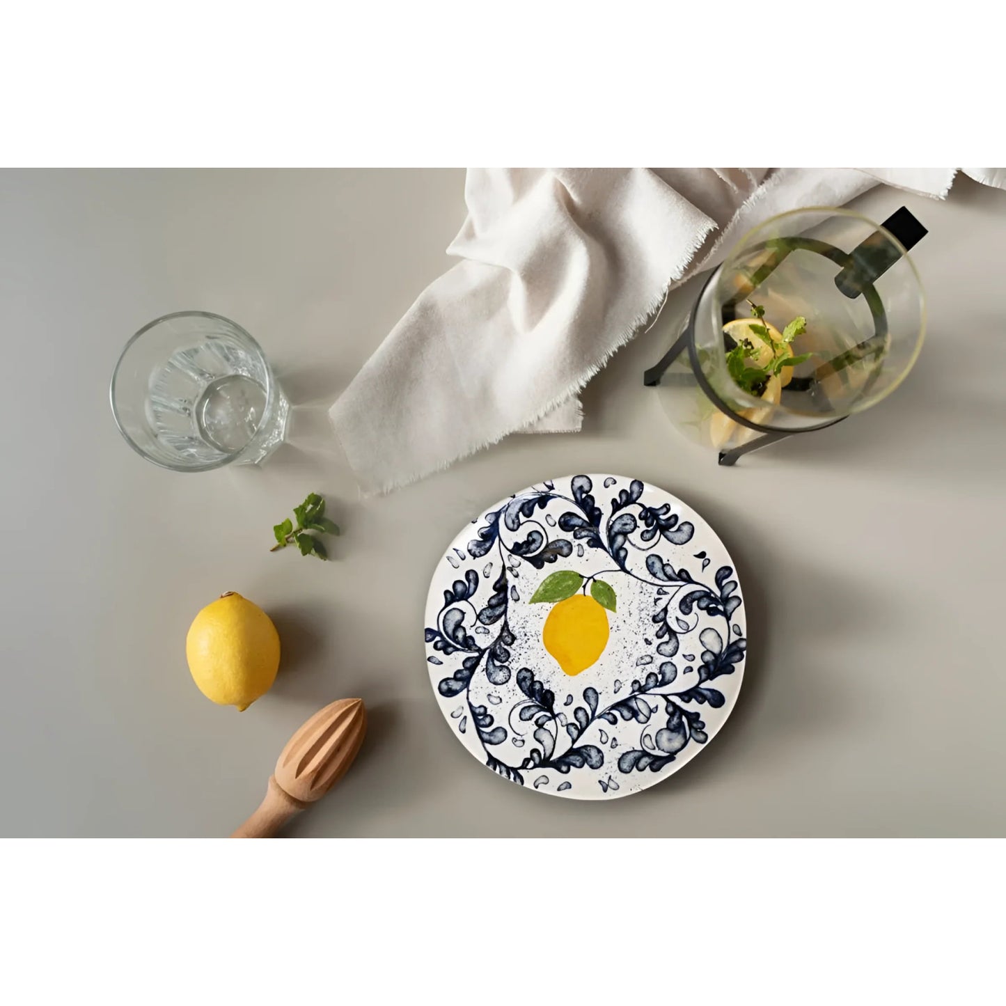 White ceramic Limoi Iberica dinner plate with blue and black swirl pattern and lemon illustration