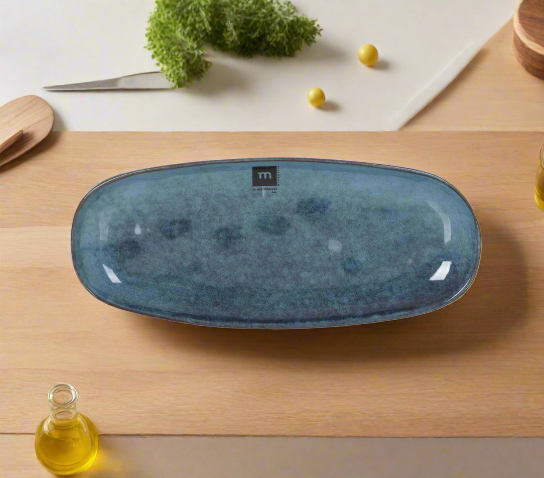 Dark blue oval ceramic serving platter with textured speckled finish for desserts and tapas