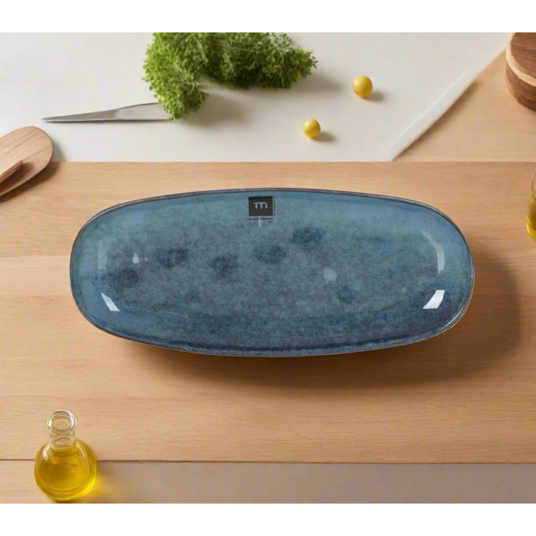 Dark blue oval ceramic serving platter with textured speckled finish for desserts and tapas