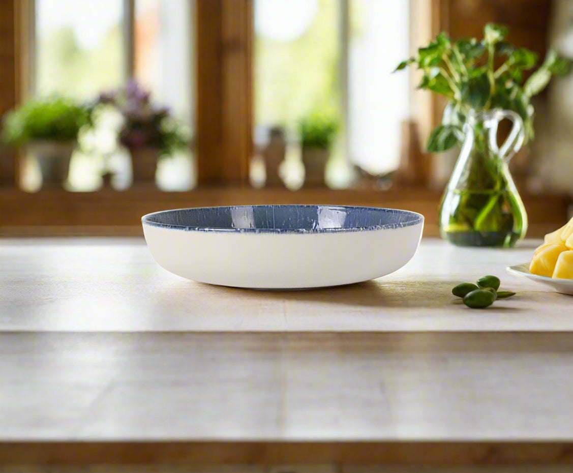 Nordic Olaf 23cm stoneware pasta bowl with white exterior and textured blue interior