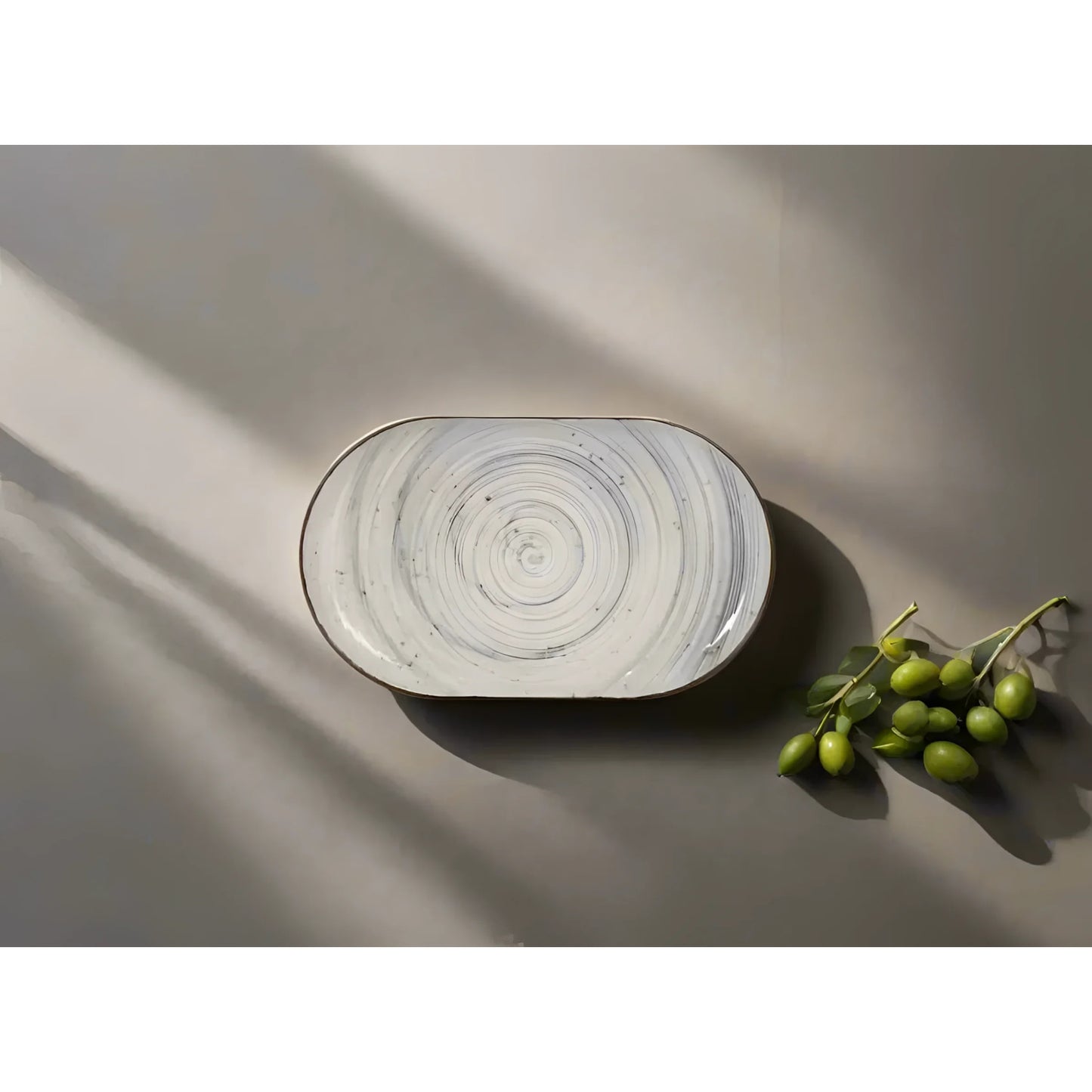 Oval stoneware serving platter with grey swirl relief decorative pattern