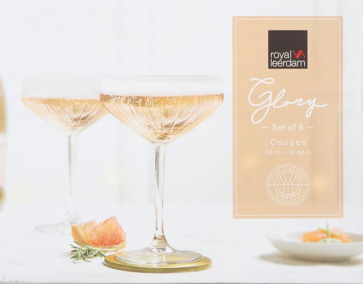 Two Vintage Royal Leerdam Glory champagne coupe glasses filled with sparkling light-colored liquid