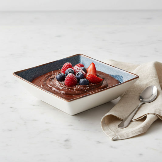 A square ceramic bowl with a speckled blue interior and a warm brown rim, shown alongside a matching square sample tile on a plain white background.