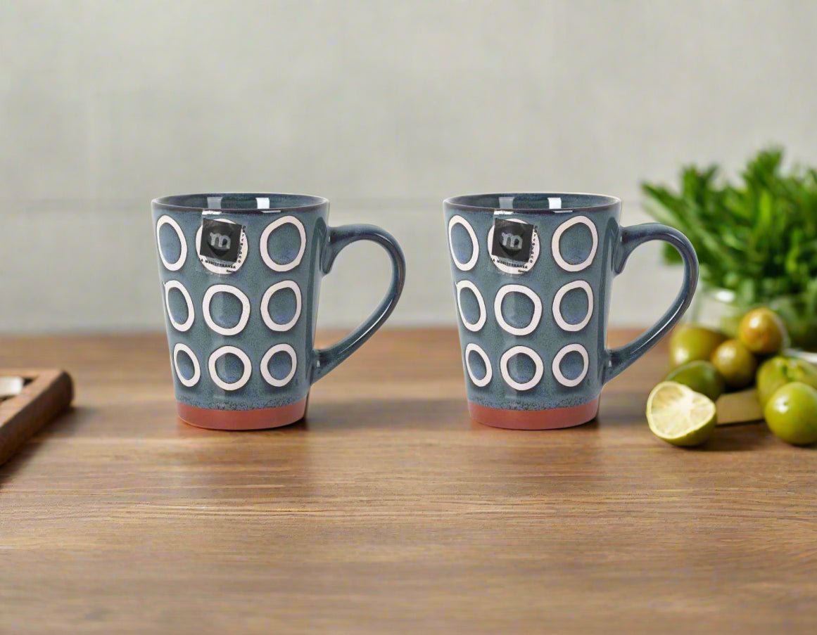 Dark teal Almudena Blue Coffee Mug with white circle patterns and reddish-brown base