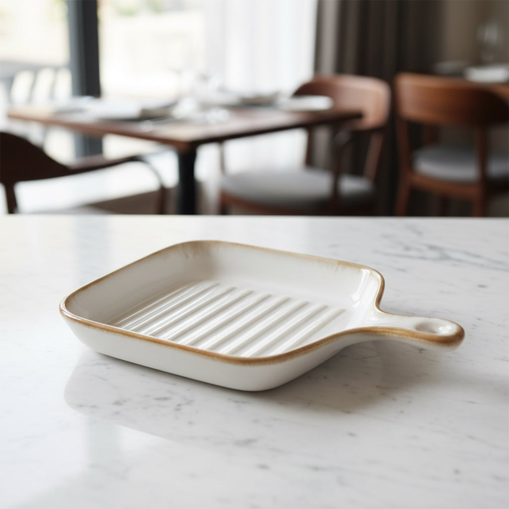 Rectangular ceramic grill pan with handle on a white background