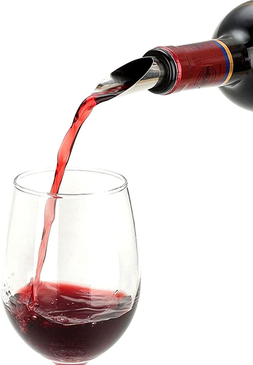 Red wine pouring from a bottle into a clear glass with Metal Aerator wine bottle stopper