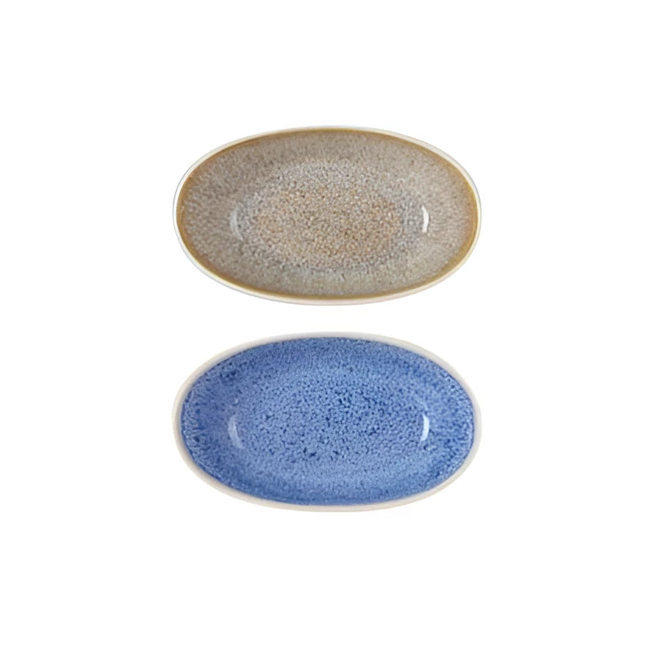 Two oval Pica Pica ramekins, speckled beige and vibrant blue glazes