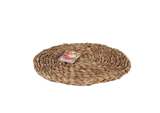 Round woven placemat made of natural brown fibers for table setting decor