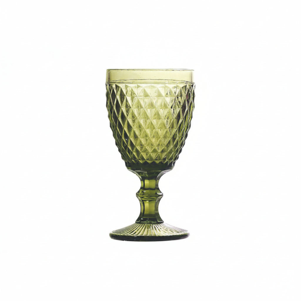 Green textured glass goblet on a white background