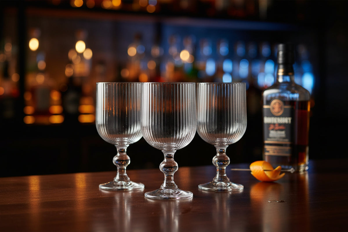 A clear ribbed glass goblet with a flared base, shown on a plain white background.