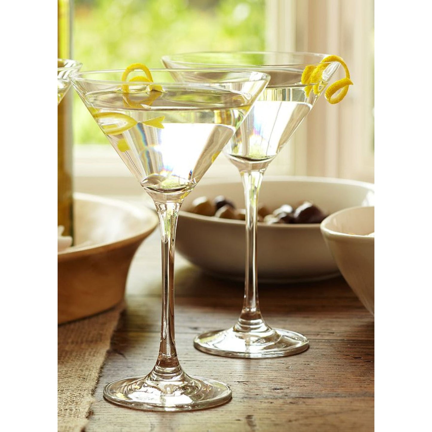Two clear Royal Leerdam Specials Cocktails Martini Glasses with lemon twists