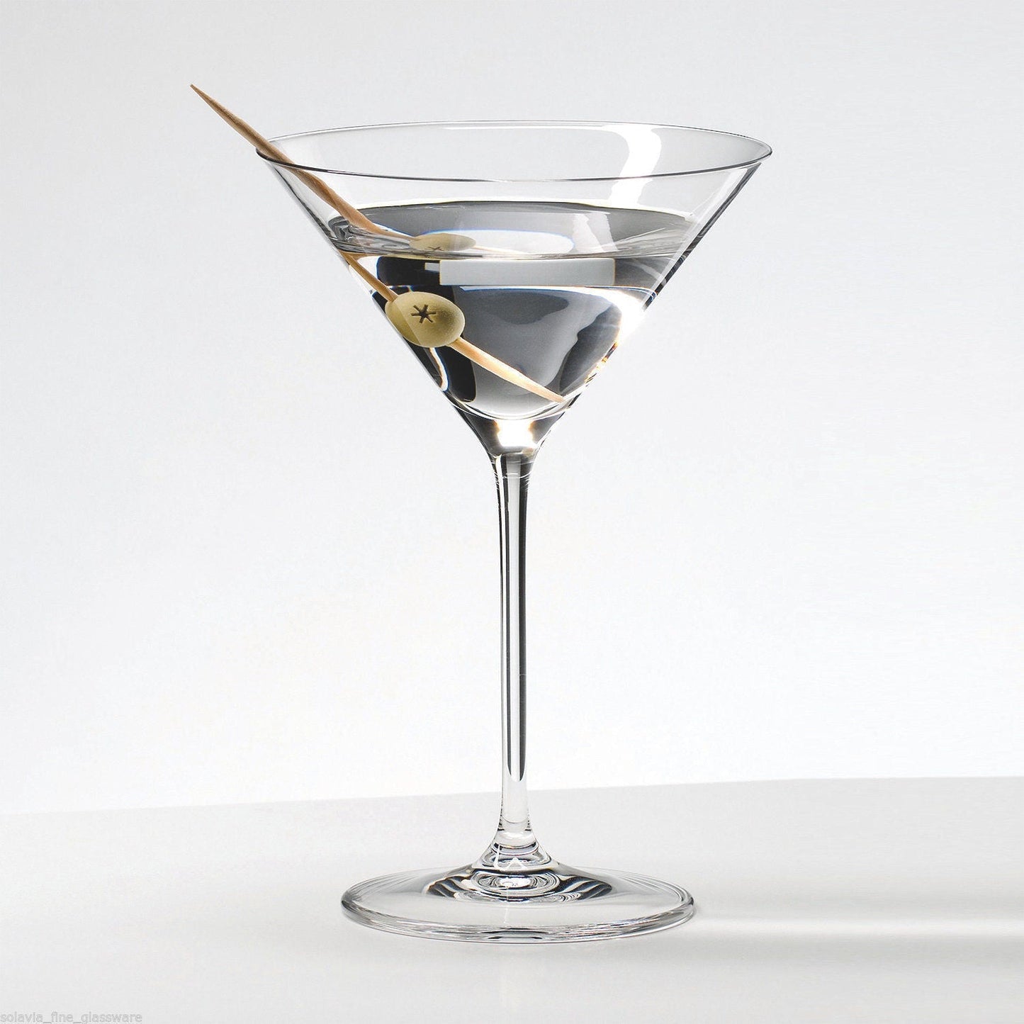 Martini glass filled with beverage and olive garnish in Royal Leerdam Specials Cocktails Glass